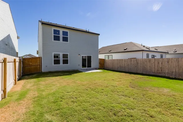 a view of a house with a backyard