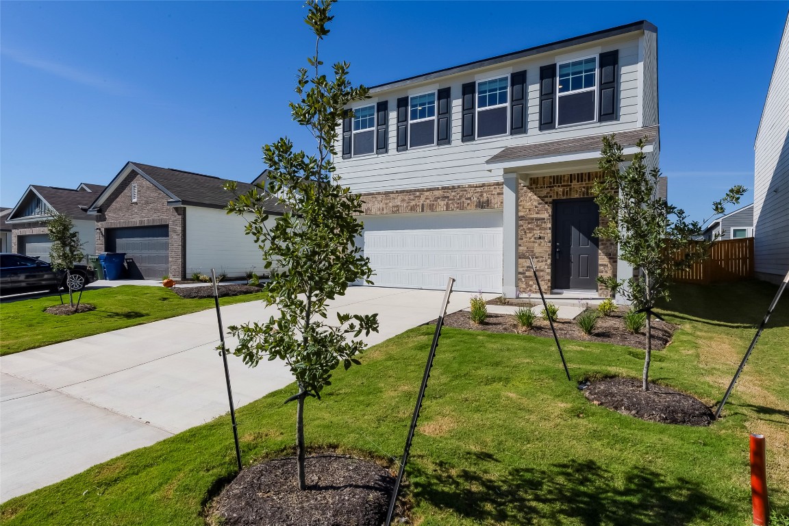 344 Enforcer Loop Jarrell, TX 76537 - Photo 5 of 34 a backyard of a house with table and chairs