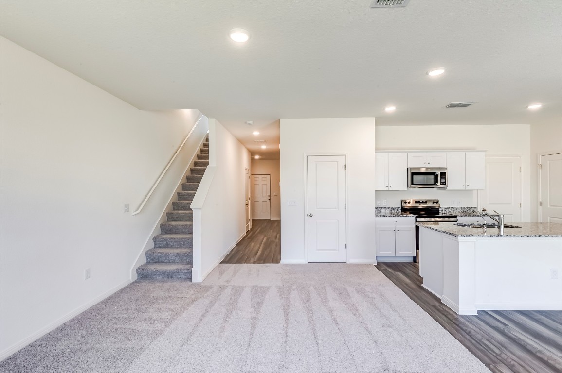 344 Enforcer Loop Jarrell, TX 76537 - Photo 9 of 34 a view of a kitchen with wooden floor and electronic appliances