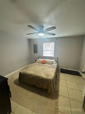 a bedroom with a bed and a television