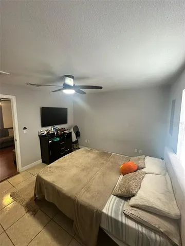 a bedroom with bed and a chandelier