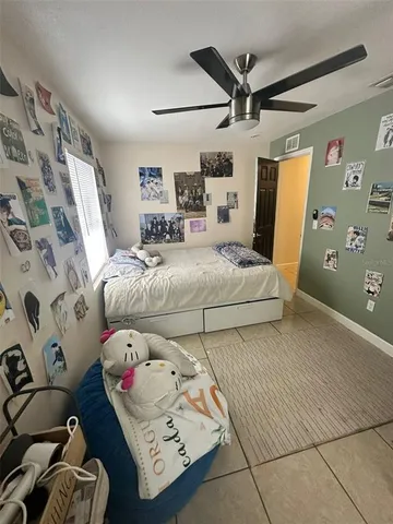 a bedroom with furniture and a large window