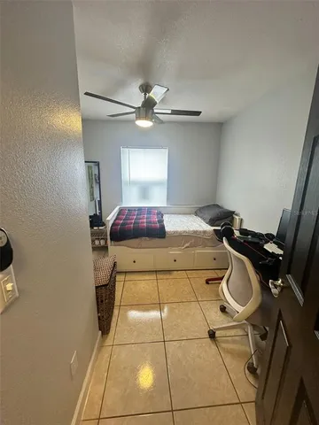 a bed room with a bed and a television