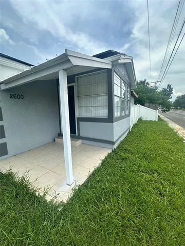 a view of house with backyard and garden