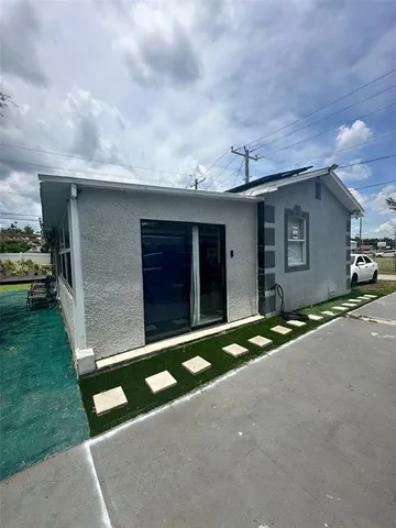 a backyard of a house with lots of green space and wooden fence