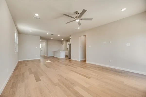 a view of an empty room with a ceiling fan
