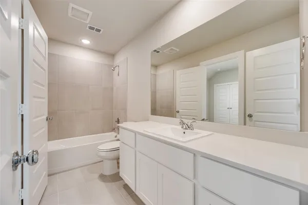 a bathroom with a double vanity sink toilet mirror and shower