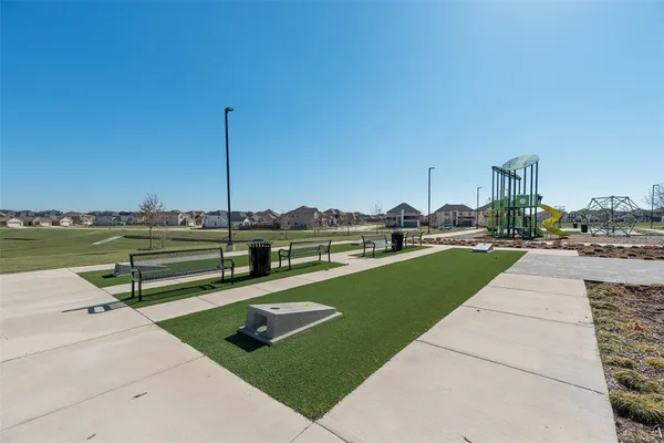a view of a garden with lawn chairs