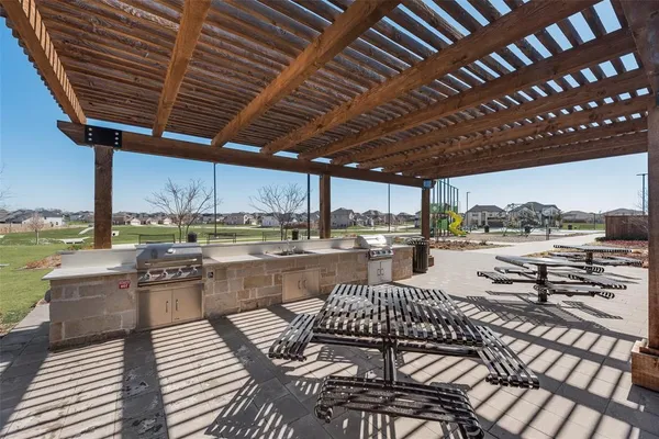 a outdoor patio with swimming pool table and chairs