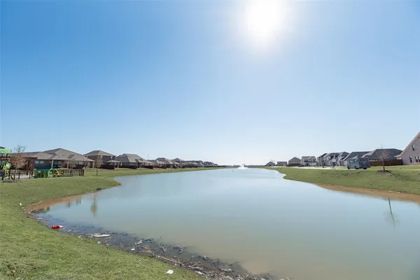 a view of a lake with houses in the back