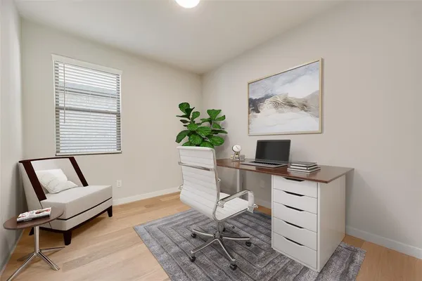 a workspace with furniture and a potted plant