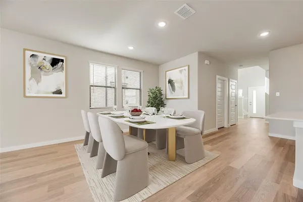 a view of a dining room with furniture window and wooden floor