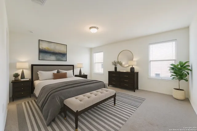 a bedroom with a bed and a potted plant