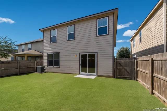 a front view of house with yard and parking