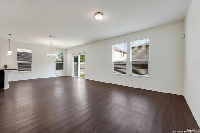 a view of a livingroom with wooden floor and window