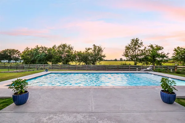 a view of swimming pool with a lounge chair