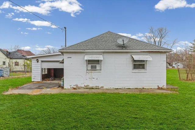 a front view of house with yard and outdoor seating