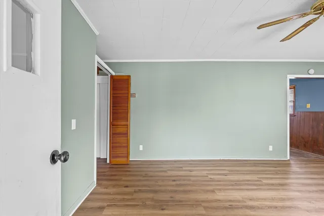 a view of an empty room with wooden floor