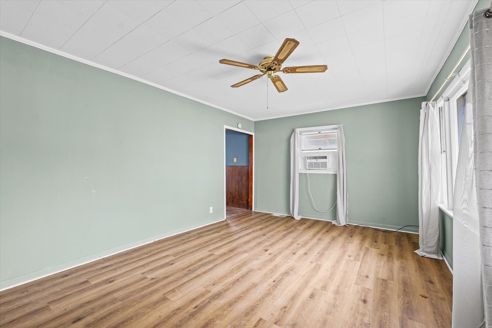218 West Elm Street Hoopeston, IL 60942 - Photo 5 of 25 a view of a big room with wooden floor and windows