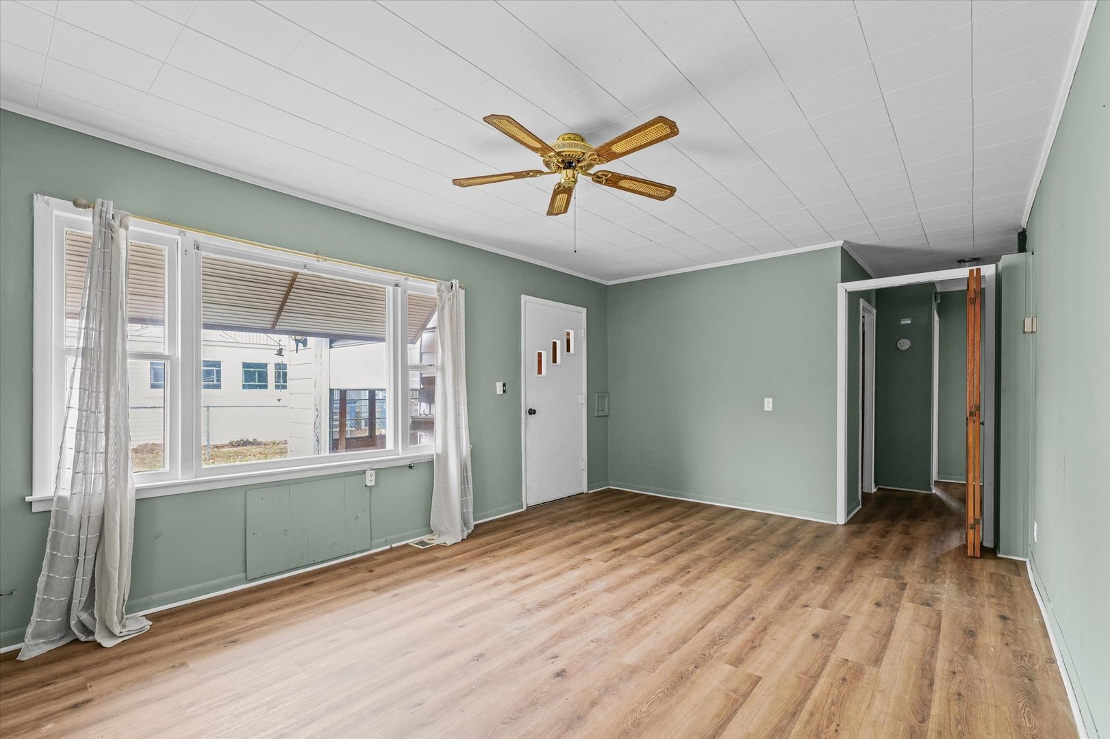 218 West Elm Street Hoopeston, IL 60942 - Photo 7 of 25 a view of an empty room with window and wooden floor