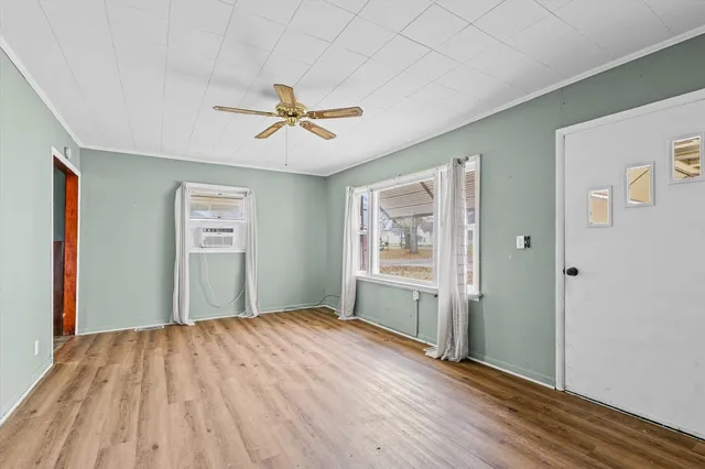 a view of empty room with wooden floor