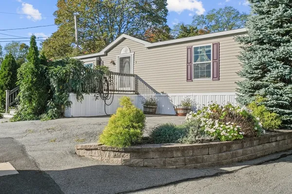 a view of a house with a yard and plants