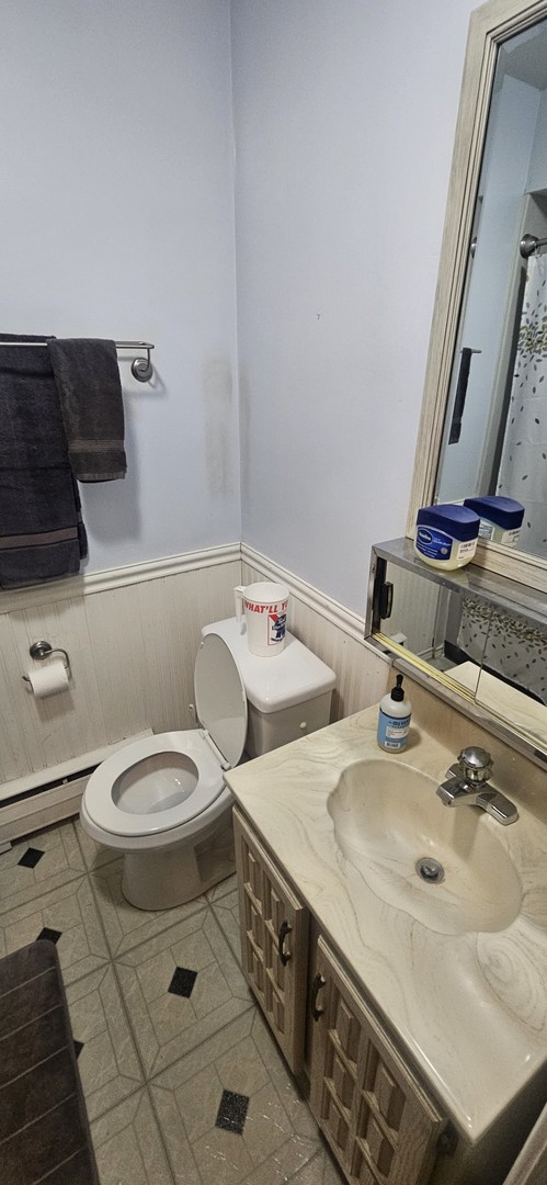 1539 Harlem Avenue, Unit 1W Oak Park, IL 60130 - Photo 7 of 9 a bathroom with a sink toilet and mirror
