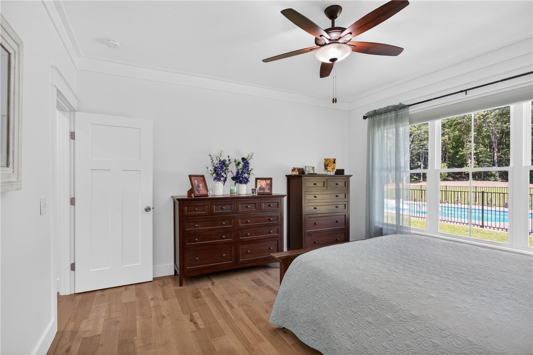 921 Falling Waters Lane Seneca, SC 29672 - Photo 22 of 46 Hardwood floors and generous natural light define this inviting bedroom.