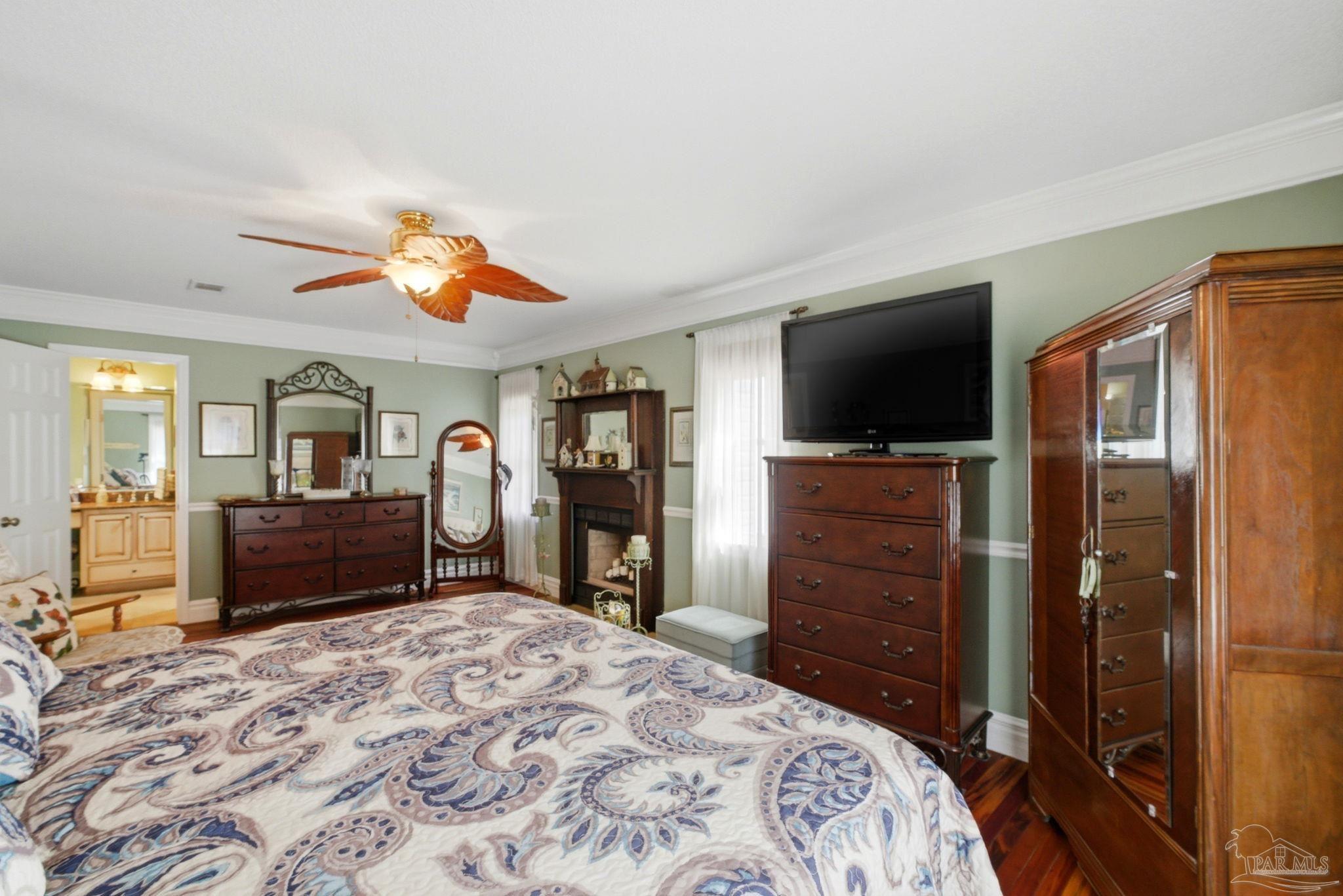 6930 Summit Way Milton, FL 32570 - Photo 27 of 71 a bedroom with a bed and a television