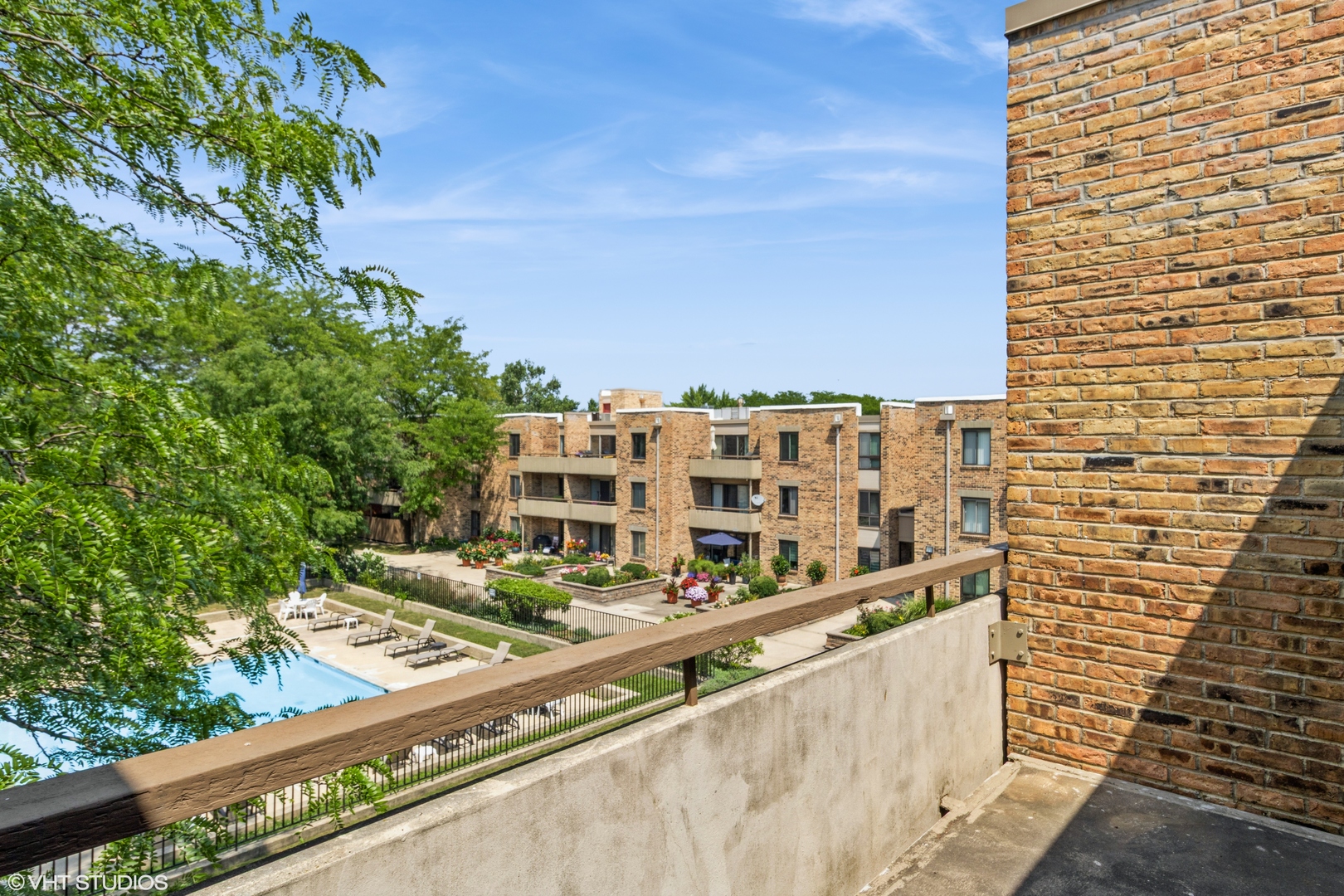 1926 Prairie Square, Unit 328 Schaumburg, IL 60173 - Photo 14 of 15 a view of balcony with wooden floor and fence