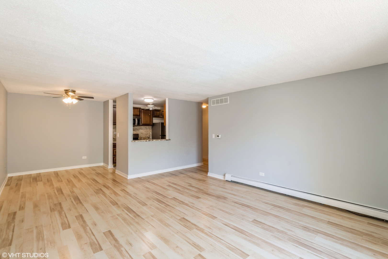 1926 Prairie Square, Unit 328 Schaumburg, IL 60173 - Photo 5 of 15 an empty room with wooden floor and windows