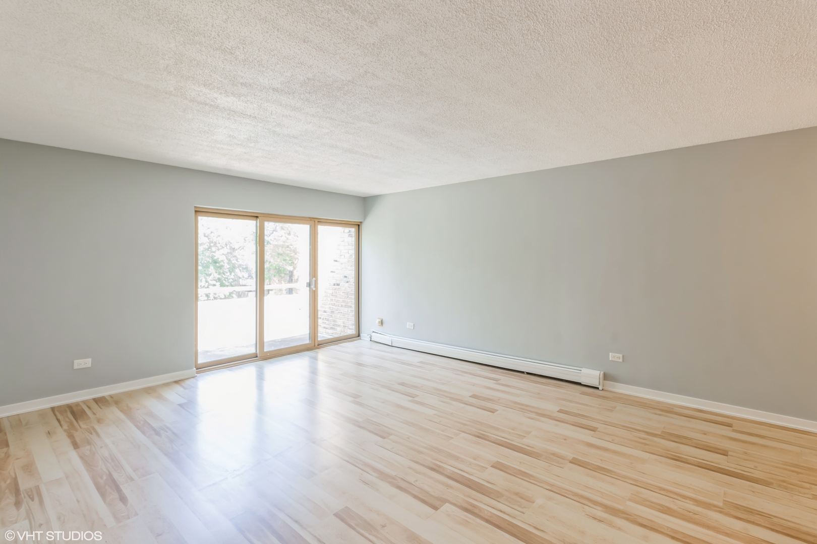 1926 Prairie Square, Unit 328 Schaumburg, IL 60173 - Photo 6 of 15 a view of an empty room with wooden floor and a window