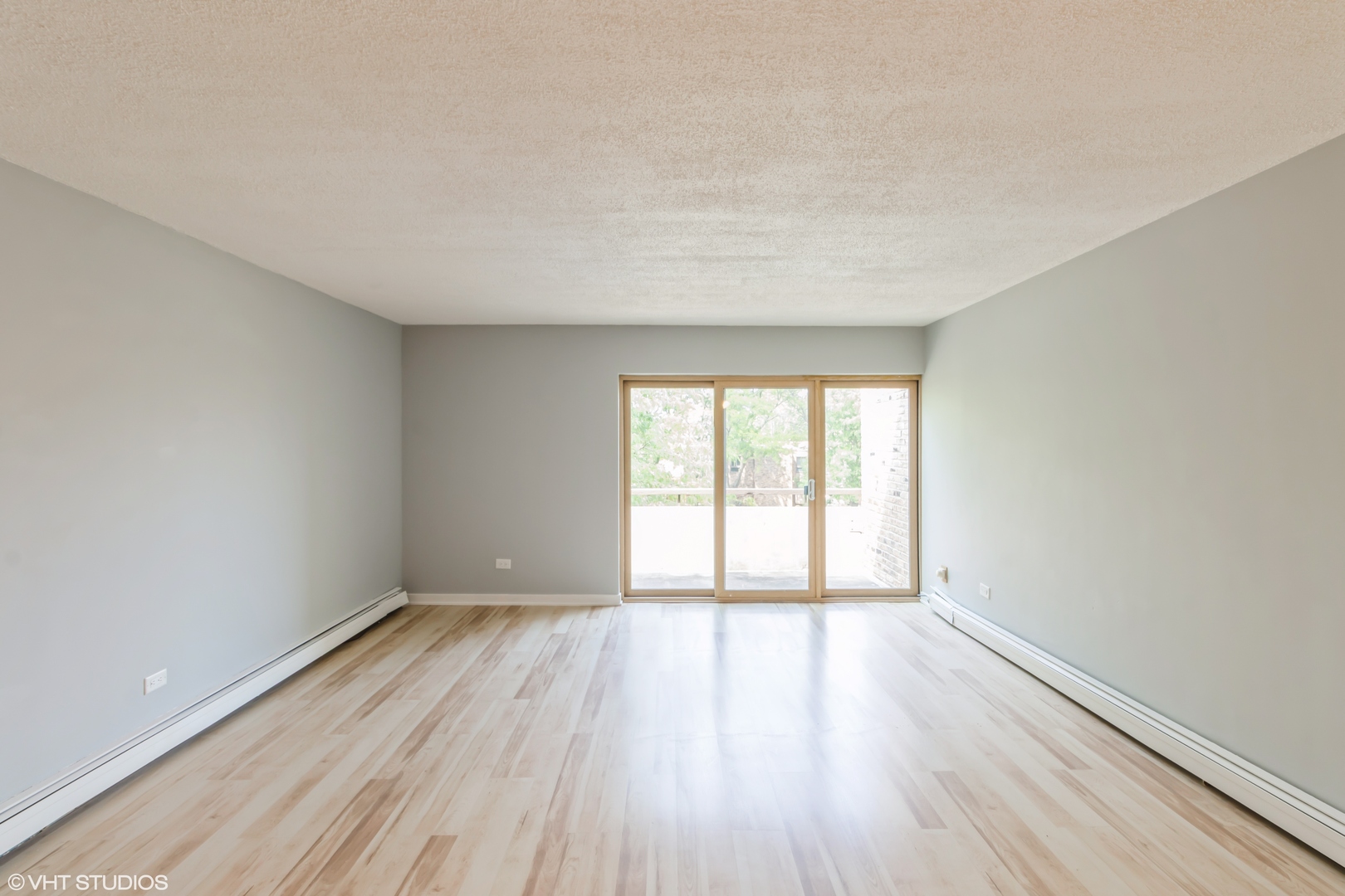 1926 Prairie Square, Unit 328 Schaumburg, IL 60173 - Photo 7 of 15 wooden floor in an empty room with a window
