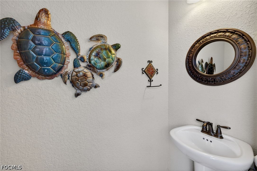 6109 Calusa Rdg Trail Bokeelia, FL 33922 - Photo 39 of 48 a bathroom with a sink and a mirror