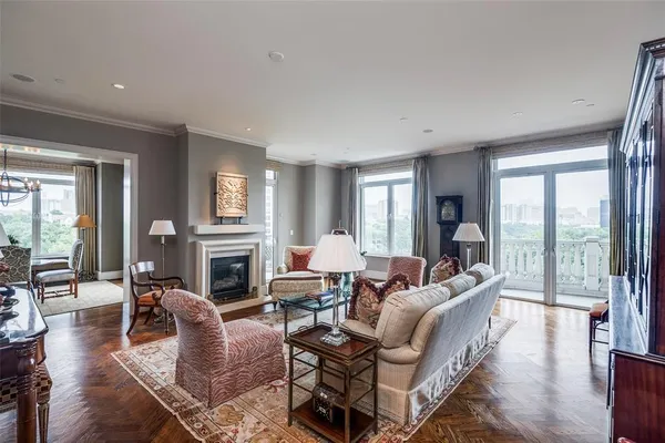 a living room with fireplace furniture and a large window