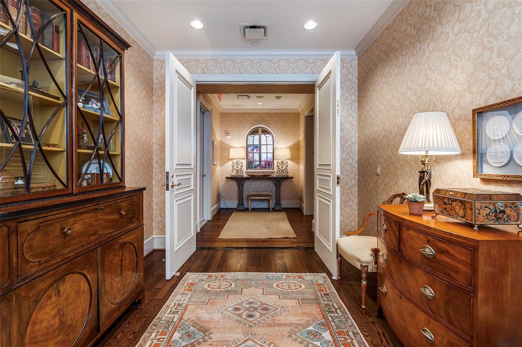 3505 Turtle Creek Boulevard, Unit 5A Dallas, TX 75219 - Photo 16 of 28 Hall featuring crown molding, dark wood-style flooring, wallpapered walls, and recessed lighting