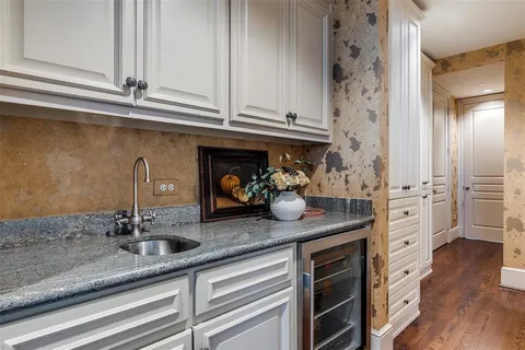 a kitchen with stainless steel appliances granite countertop a sink and cabinets
