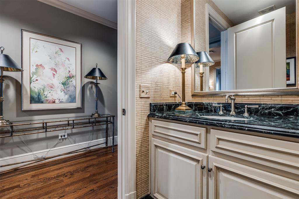 3505 Turtle Creek Boulevard, Unit 5A Dallas, TX 75219 - Photo 20 of 28 Bathroom with vanity, dark wood-style flooring, and crown molding