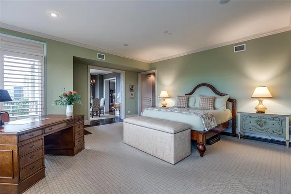 a spacious bedroom with a large bed and windows