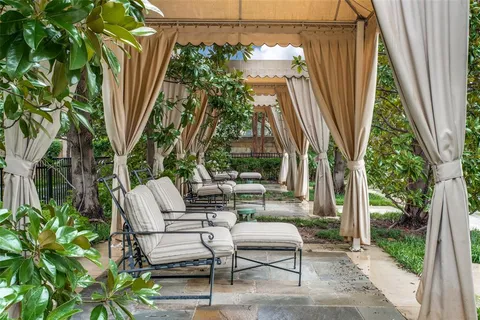 a view of backyard with outdoor seating and plants