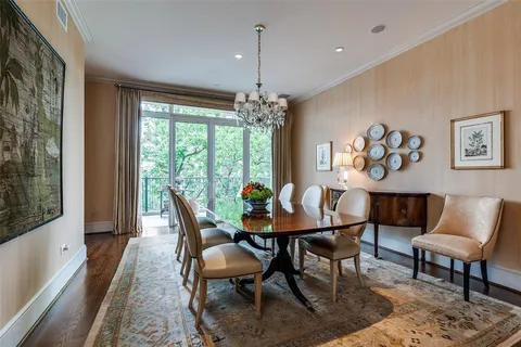 a dining room with furniture a chandelier and wooden floor