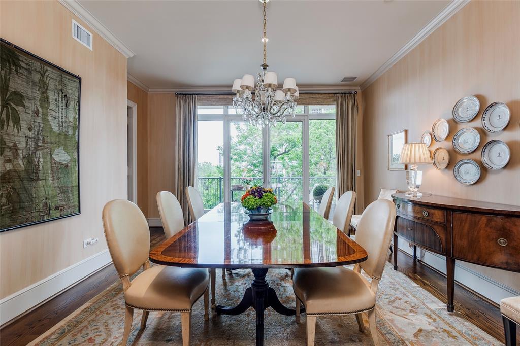 3505 Turtle Creek Boulevard, Unit 5A Dallas, TX 75219 - Photo 4 of 28 Dining area featuring crown molding, wood finished floors, healthy amount of natural light, and a chandelier