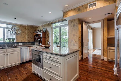 a kitchen with stainless steel appliances granite countertop a stove and cabinets