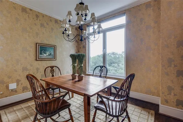 a view of a dining room with furniture wooden floor and chandelier