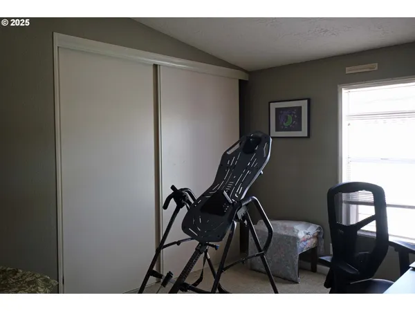 a view of a hallway with chair and table