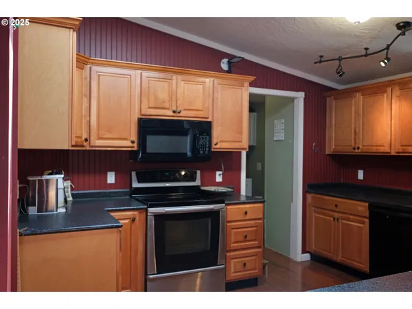 a kitchen with stainless steel appliances a stove microwave and cabinets