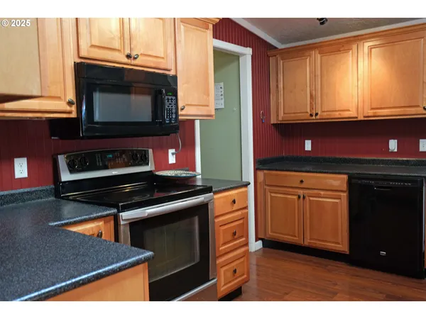 a kitchen with stainless steel appliances a stove cabinets and a microwave