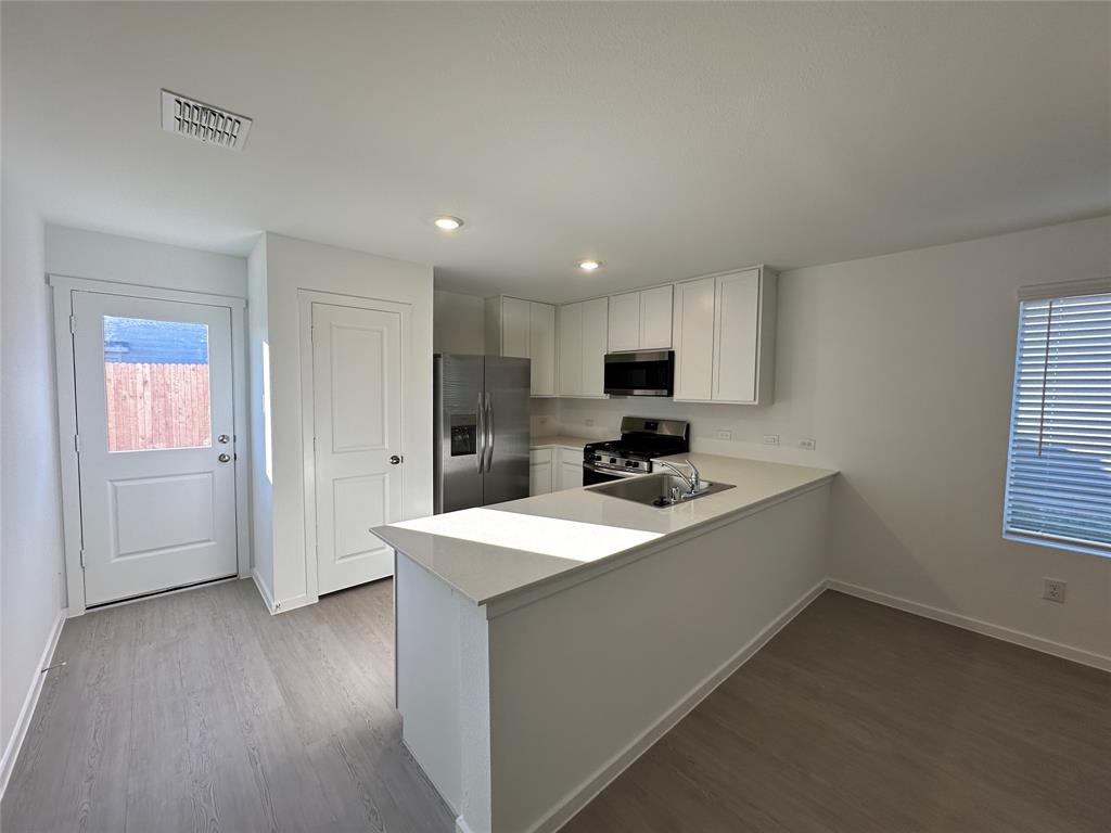 3928 Pontchartrain Parkway Sherman, TX 75090 - Photo 4 of 13 a kitchen with a sink a stove cabinets and a refrigerator