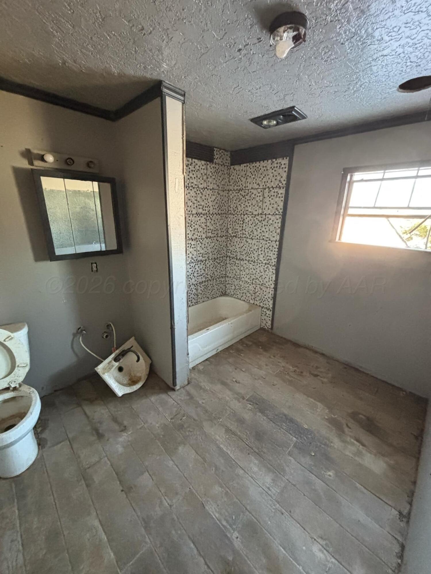 4201 Long Drive Amarillo, TX 79108 - Photo 6 of 7 a bathroom with a toilet sink and shower