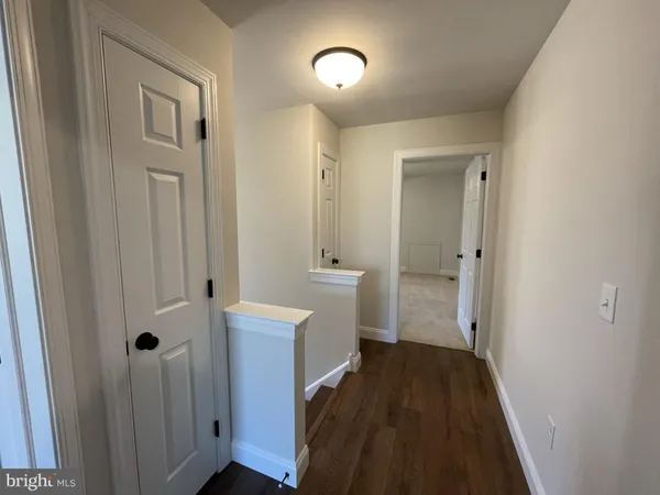 a view of an entryway with wooden floor